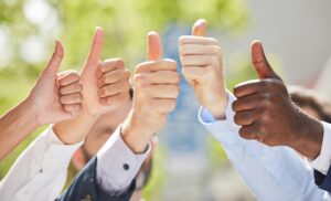 Shot of a group of unrecognizable businesspeople showing a thumbs up